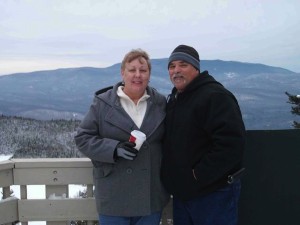 Richard and wife standing with a snowy mountain background